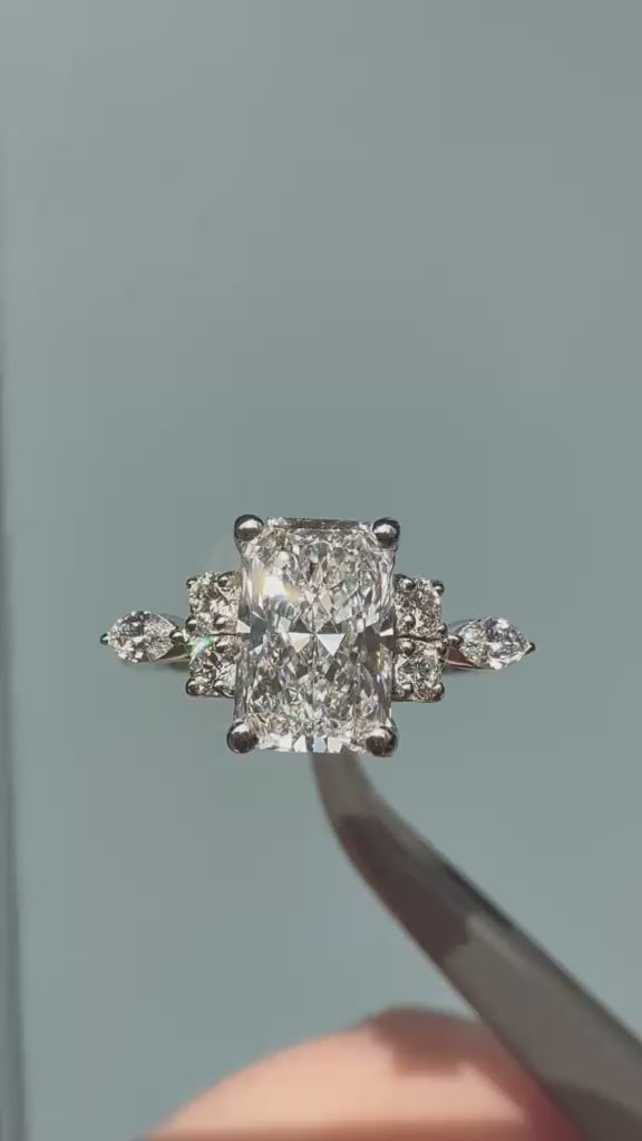 Emerald cut with a trefoil of Round and marquise diamonds